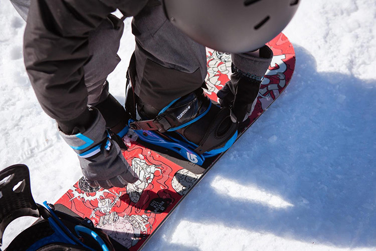 a close up of snowboard boots strapped into a snowboard