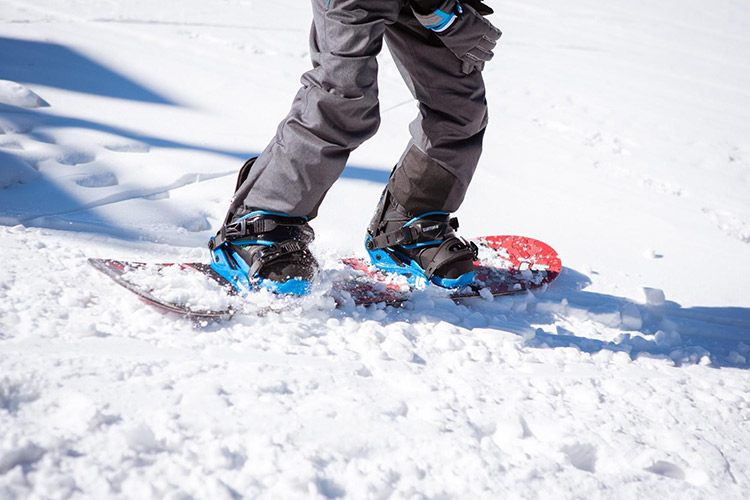 digging in the edge of the snowboard into the snow to slow down