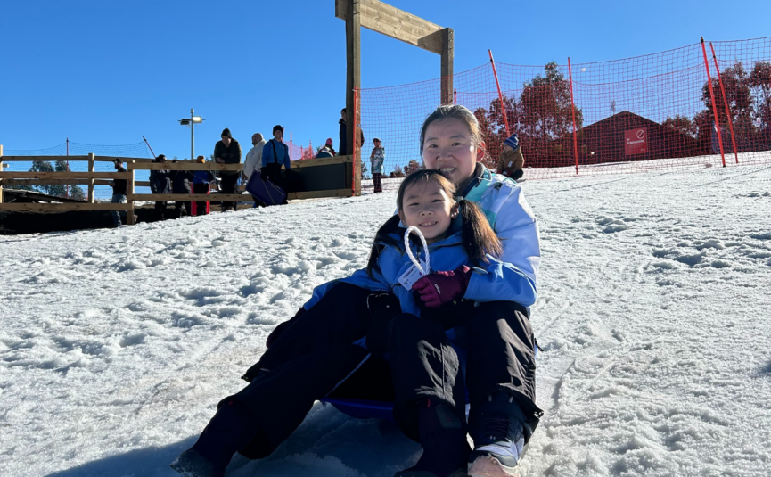 mother and child tobogganing