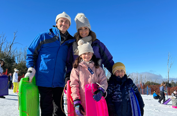 family with toboggans